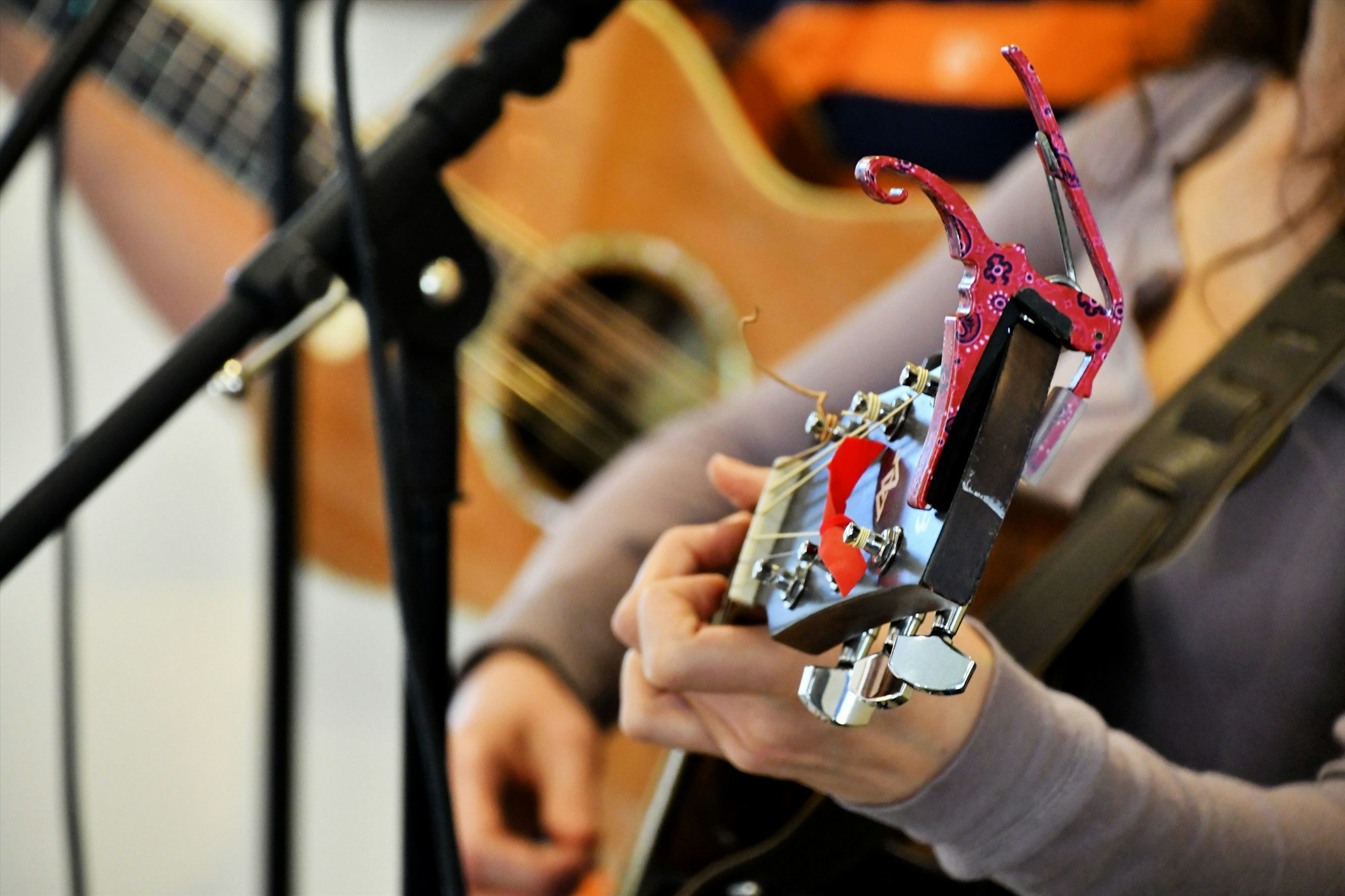 live-music-at-a-festival-female-playing-her-guitar-while-singing-performing-music-live-on-stage-.jpg